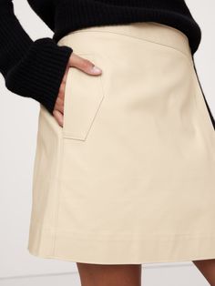 This classic mini skirt has utility-inspired flap pockets at the sides and a wrap-front construction.  For fabric, we reached for a special cotton canvas that's specially washed to its both soft and structured.  High rise.  A-line fit.  Hidden, adjustable button and hook-and-bar closure.  Side seam pockets.  Unlined.  A-line fit.  Mini length.  Model: Size S, 5'10" (178cm). Cotton Mini Skirt With Belt Loops For Work, Spring Fitted Cargo Skirt With Patch Pockets, Fall Cotton Mini Cargo Skirt, Cotton Mini Cargo Skirt For Fall, Cotton Skort With Pockets For Fall, Fitted Cargo Skirt With Patch Pockets For Spring, Fall Cotton Skort With Pockets, Spring Fitted Wrap Skirt With Pockets, Mini Length Shorts With Pockets For Fall