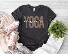 Yoga Empress Shirt, Yoga Tshirt, Meditation Tshirt, Namaste Shirt, Gift for Yogi, Women Yoga Shirt, Positive Shirt, Yoga Outfit, Yoga Shirt ⭐Production Time 1-3 Business Days ⭐Shipping Time 1-5 Days for U.S. Orders. ⭐ Sizing & Color info in the PHOTOS section of every listing.       -All normal listings are Adult Unisex. ⭐ Bella & Canvas Adult Unisex T-Shirts:        - Solid Colors are 100% Soft Cotton        - Heather Colors are Soft Blended Fibers ⭐HOW TO LOVE YOUR TEES:       -Wash inside out with like colors.       -Tumble dry low or hang to dry.       -Try not to iron directly over the design. Also, don't iron t-shirts! Sporty Yoga T-shirt With Letter Print, Sporty Letter Print Tops For Yoga, Comfortable Athleisure T-shirt With Letter Print, Comfortable Athleisure Letter Print T-shirt, Athleisure T-shirt With Letter Print And Comfortable Fit, Stretch Athleisure T-shirt With Letter Print, Graphic Print Short Sleeve Tops For Yoga, Stretch Cotton Yoga T-shirt, Cotton Stretch T-shirt For Yoga