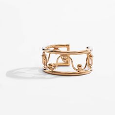 One of two cuffs in this collection, the Imba Statement Cuff stands out as the more formal option. Radiating elegance, the ornate and curvy design makes this a standout piece. With its high-polish finish, it will complement any formal look. Hand-placed by our skilled artisans, the spheres that accentuate each curve, symbolize our commitment to craftsmanship. This cuff is made from recycled brass and plated in 24K gold. Dimensions: Height 1.06in (27mm) IMBA, which means "sing" in Swahili, is insp Metal Cuff Bracelet For Formal Occasions, Chic Formal Jewelry With Open Band, Chic Formal Open Band Jewelry, Luxury Polished Cuff Bracelet, Elegant Metal Cuff Bracelet With Polished Finish, Elegant Metal Bangle Cuff Bracelet, Luxury Metal Evening Cuff Bracelet, Elegant Open Band Cuff Bracelet, Elegant Open Band Bangle For Formal Occasions