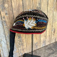 This is a magnificent example of antique Iroquois/Mohawk beadwork. This Glengarry hat/cap is fully beaded with all of the beads intact.  While there is very slight deterioration of the red fabric on the folded edge, this does not diminish the quality and collectability of this piece.  It was likely made in Canada at Kahnawake near Montreal around 1860.  Because there were numerous Scottish people in the vicinity, these hats were popular. It is a rare item and would enhance any serious Native American collection.  Just beautiful! DETAILS: Artist: Iroquois/Mohawk unknown Size: Hat itself 11 1/2" long x 4 1/4" high x 5" wide at top when opened Materials: Velvet, silk and glass seed beads Condition: Excellent. No missing beads and very slight fabric distress at the fold. (GM196) Traditional Handmade Adjustable Bonnet, Traditional Beaded Hats For Festivals, Handmade Traditional Adjustable Bonnet, Handmade Adjustable Traditional Bonnet, Traditional Beaded Festival Hats, Traditional Adjustable Costume Hat, Vintage Costume Cap For Festival, Vintage Ceremonial Headpiece For Festivals, Traditional Handmade Costume Headpieces