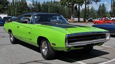 a bright green muscle car parked in a parking lot