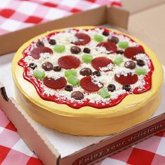 a pizza sitting on top of a table next to a box