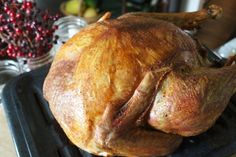 a roasted turkey sitting on top of a grill