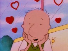 an animated image of a man sitting in front of a window with hearts hanging from it