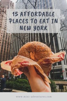 a person holding up a sandwich with the words 15 adorable places to eat in new york