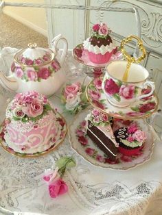 a table topped with cakes and tea cups