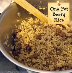 a pot full of rice with a wooden spoon in it and the words, one pot beefy rice