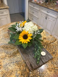 a vase filled with flowers sitting on top of a counter