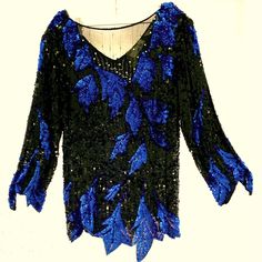 Vintage Nwot. You Will Feel So Elegant The Moment You Slip Into This Sweelo 100% Silk Hand Beaded Blouse. Black Sequined Background With Cobalt Blue Sequined Details. The Front Bodice Is Sheer Black With Rhinestones. The Back Is A Flattering V-Neck. Comes With Shoulder Pads That Are Easily Removable. Comes With Replacement Rhinestones Should They Be Needed. Please See The Fun Details On Sleeve And Hem To Accent The Blue Leaf Design. From A Smoke Free Home. Seller Reference Only: B16 Sequined Tops For Evening Winter Events, Beaded Long Sleeve Tops For Night Out, Long Sleeve Beaded Party Tops, Beaded Tops For Night Out In Fall, Beaded Tops For Fall Night Out, Winter Evening V-neck Blouse, Crew Neck Tops For Winter Evenings, Elegant Beaded Long Sleeve Tops, Elegant Long Sleeve Beaded Tops