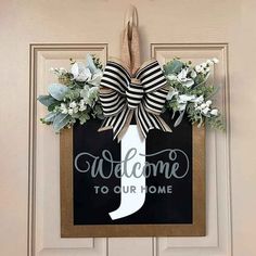 welcome to our home door hanger with ribbon and flowers on it's front door