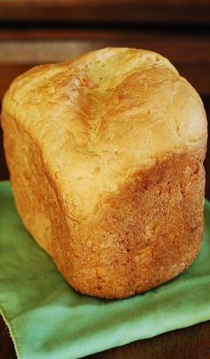 a loaf of bread sitting on top of a green napkin