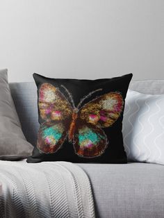 a colorful butterfly on a black background throw pillow