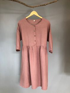 "Made from medium weight linen, this dress is very soft and swings comfortably, allowing movement in all the right places. Buttoned front and loose fit design, it will be a staple in your wardrobe for a long time to come. -100% linen construction -Below the knee length (or to be customized per request) -3/4 sleeves ( or to be customized per request) -Half front closure with buttons -Gathered waist -Two side pockets - Listing Colors: Grayish Blue, Blush, Amber, Teal Please provide your shoulder w Flowy Linen Casual Midi Dress, Flowy Linen Midi Dress Casual Style, Relaxed Fit Cotton Midi Dress With Buttons, Linen Midi Dress For Daywear, Flowy Linen Midi Dress, Spring Linen Midi Dress With Button Closure, Relaxed Linen Midi Dress For Daywear, Knee-length Linen Midi Dress For Daywear, Relaxed Fit Linen Midi Dress For Casual Wear