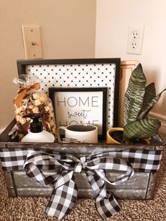 a metal box filled with assorted items on top of a carpeted floor next to a wall