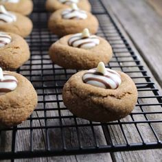 several cookies with white frosting on a cooling rack