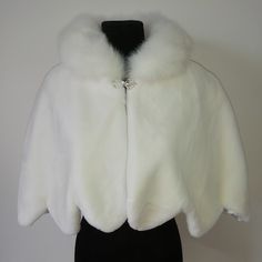 a white fur coat on a mannequin dummy