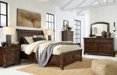 a bedroom scene with focus on the bed and dresser