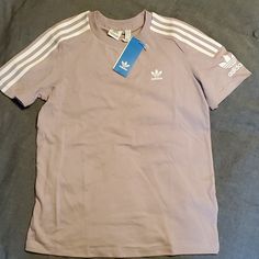 Women's Adidas Originals "Lock Up Tee". Brand New, Never Worn. Color Is A Light Lilac. Spring Adidas Three Stripes Top, Adidas Tops With Three Stripes For Spring, Adidas Short Sleeve Spring Shirt, Adidas Crew Neck Shirt For Spring, Adidas Short Sleeve Shirt For Spring, Spring Adidas Cotton Shirt, Adidas Cotton Shirt For Spring, Adidas Casual Shirt For Spring, Casual Adidas Shirt For Spring