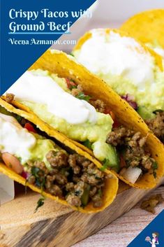 two tacos with ground beef, avocado and sour cream