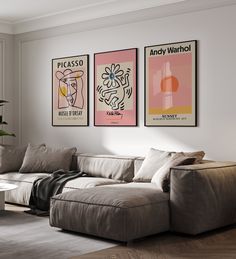 a living room with three posters on the wall