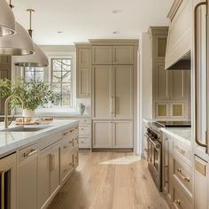 a large kitchen with wooden floors and white cabinets