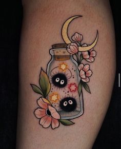 an image of a tattoo with flowers and moon in a jar on the thigh or leg