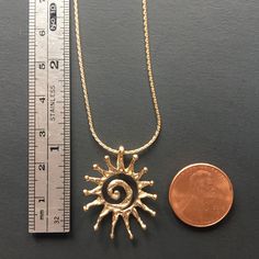 "This is now the largest sun I currently make in gold; it measures 1-1/16\" tall by 7/8\" wide (27x22mm) and is quite a bit heavier thank the \"Large\" sun version. Hot summer sun in solid recycled 14k gold! (Melted down old pieces, not newly mined out of the ground). This is my design that I made here in my studio. I sculpt the shape out of jewelers wax, and using a kiln, torch and centrifuge; cast it into solid 14k gold. I offer this pendant alone or with a beautiful 18\" solid 1mm 14k Wheat c 14k Gold Necklaces With Sun Design, Yellow Gold Brass Jewelry With Sun Design, Gold Sun Design Pendant Jewelry, 14k Yellow Gold Jewelry With Sun Design, 14k Yellow Gold Sun Design Jewelry, 14k Gold Sun Design Necklaces, 14k Gold Sun Design Necklace, 14k Yellow Gold Sun Design Necklace, Gold Jewelry With Sun Design In 14k Gold