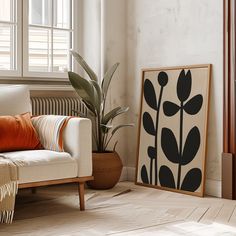 a living room with a couch, plant and window