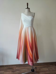 a dress on a mannequin stand in front of a white wall and wooden floor