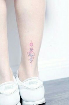 a woman's foot with a tattoo on her left leg and the word love written in pink ink