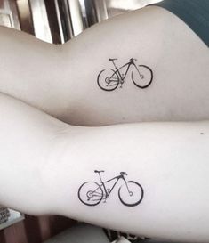 two people with tattoos on their arms and legs, one has a bicycle tattoo on the other