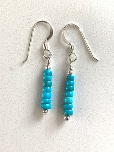 These are a pair of simple turquoise and sterling silver earrings. The turquoise is from the Kingman mine in Arizona. The rondelle beads are petite at 3-4 mm. There are teeny tiny sterling spacer beads at either end of the turquoise.  The earrings measure about 1 1/2 inches tall and will be secure on your ears with shepherd hook ear wires.  These earrings are quite petite!   These are the exact earrings you will be receiving, already made and ready to ship immediately. Designed and made by me. P Sterling Silver Blue Jewelry With Tiny Beads, Blue Sterling Silver Jewelry With Tiny Beads, Turquoise Round Bead Earrings For Everyday, Sterling Silver Dangle Jewelry With Tiny Beads, Sterling Silver Earrings With Tiny Round Beads, Everyday Turquoise Round Bead Earrings, Everyday Turquoise Beaded Earrings, Turquoise Wire Wrapped Beaded Earrings As Gift, Turquoise Earrings With Tiny Beads For Gift