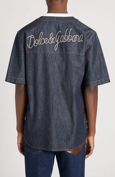 Designed as part of the fashion house's Palermo collection, this softly oversized bowling shirt is cut from indigo-dyed denim and boasts a rope-style back logo. Front snap closure Crewneck Elbow-length sleeves Curved hem 100% cotton Machine wash, line dry Made in Italy Designer Clothing Designer Embroidered Collared Tops, Luxury Embroidered Cotton Tops, Dyed Denim, Bowling Shirt, Bowling Shirts, Embroidered Denim, Elbow Length Sleeve, Palermo, Bowling