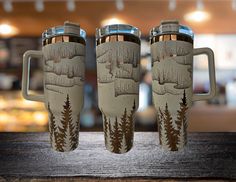 two coffee mugs sitting on top of a wooden table