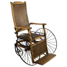 an old wooden wheel chair with wheels on the front and back, against a white background