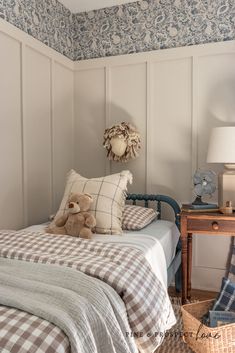 a bed room with a neatly made bed and a teddy bear