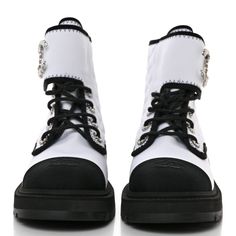 This is an authentic pair of CHANEL Fabric Grosgrain Quilted Cap Toe Lace Up Combat Boots size 38.5 in White and Black. These chic combat boots are crafted of quilted fabric in white and black grosgrain cap toes with an embroidered Chanel CC logo. They feature a 1.75-inch heel and 5.5-inch shaft, a sturdy rubber base sole, and black laces. Chanel Fabric, Lace Up Combat Boots, Quilted Fabric, Cc Logo, Chanel Shoes, Black Laces, Combat Boots, White And Black, Chanel