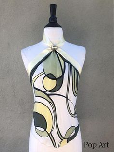 Created from upcycled scarf fabrics, each halter top in this collection is one of a kind. A simple triangle top with a retro vibe, this halter top is fastened at the back neck with a button closure and tied at the back waist with a double faced satin ribbon. Ribbon can also be tied in front for a waist accent. An easy feminine top to wear on hot summer days. Silk Chic Fitted Multi-way Halter Top, Silk Halter Neck Top With Tie Back, Green Sleeveless Halter Top With Tie Back, Summer Multi-way Halter Neck Top, Summer Multi-way Halter Top, Multi-way Halter Neck Top For Summer, Multi-way Halter Neck Top For Party, Silk Halter Neck Dress With Tie Back, Fitted Multi-way Halter Top For Summer