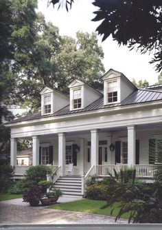 a white house with porches and columns