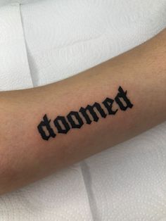 a person with a tattoo on their arm that says, 'oomet'in cursive font