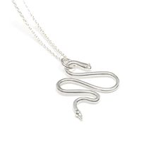 Silver Necklace - A whimsical, sterling silver, handcrafted snake charm hangs from a delicate bright or oxidized silver chain.  Hang your favorite charm from the snake and use it as a charm holderor wear it alone layered with your other necklaces!<br> Available in 16, 18, 20 lengths in sterling or oxidized silver. Lobster clasp closure. Silver Snake Necklace, Slithering Snake, Snake Necklace Silver, Snake Shedding, Charm Holder, Snake Pendant, Silver Jewelry Necklace, Snake Necklace, Artful Home