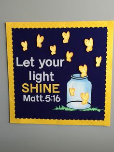 a blue and yellow bulletin board with butterflies on it that says let your light shine matt 516