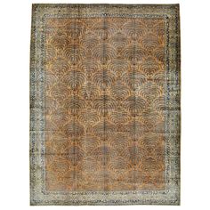 an antique rug with brown and blue colors