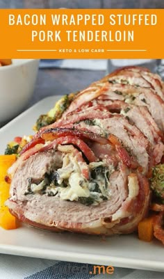 bacon wrapped stuffed pork tenderloin on a white plate