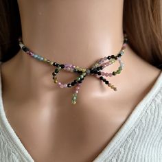 Indulge in the ultimate luxury with our Beaded Bow Necklace featuring colorful natural Tourmaline beads. This exquisite piece exudes elegance and charm, making it the perfect gift for her. Handcrafted with meticulous detail, this coquette jewelry piece is a true work of art. Beautiful handmade jewelry. The intricate design of the bow choker for women showcases delicate beadwork and a striking bow tie pendant that will surely make a statement wherever you go. ♥ HIGH QUALITY MATERIALS ♥ This adjus Adjustable Multicolor Faceted Beads Choker, Multicolor Faceted Beads Crystal Necklace As Gift, Multicolor Gemstone Bead Choker Necklace, Multicolor Crystal Necklace With Faceted Beads As Gift, Multicolor Gemstone Beads Choker Necklace, Multicolor Gemstone Beaded Choker Necklace, Multicolor Crystal Choker Necklace For Gift, Multicolor Polished Beads Choker As Gift, Elegant Multicolor Round Beads Choker