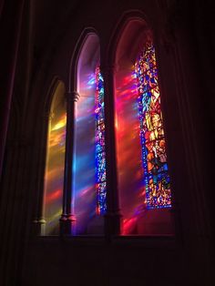 two stained glass windows in a church with sunlight streaming through them and the light coming through them