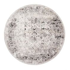 a round rug with black and white designs on the bottom, in front of a white background