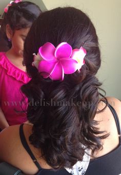 two girls with pink flowers in their hair