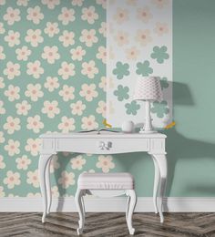 a white desk with a lamp on top of it next to a flower wallpaper