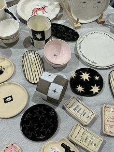 many different plates and bowls on a table